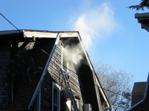 Smoke was seen billowing out of the attic window
